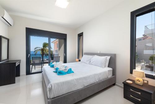 a bedroom with a large bed and a large window at Ixia Breeze 3 in Ixia
