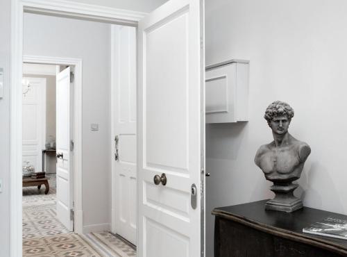 a bust of a man on a table in a room at BCN Rambla Catalunya Apartments in Barcelona