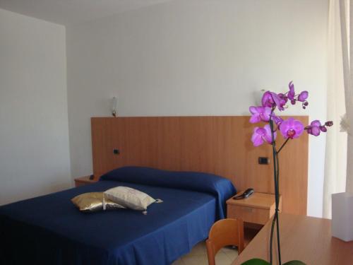 Postel nebo postele na pokoji v ubytování Hotel Maggiore