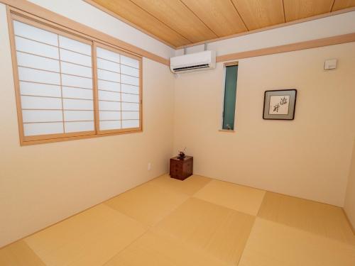 an empty room with a window and a fan at Kamakura International House Japanese-style room w Shower Toilette Min 1 female guest - Vacation STAY 11630 in Kamakura