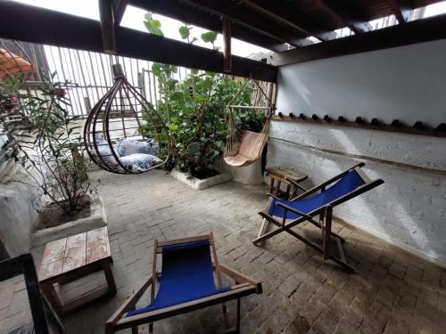 a room with two chairs and a hammock on a patio at Mancora Apartments in Máncora