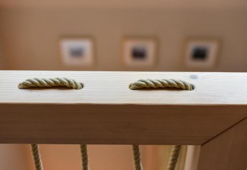 two rope knots on top of a wooden table at JULIAN VILLAGE LEPENA in Soča