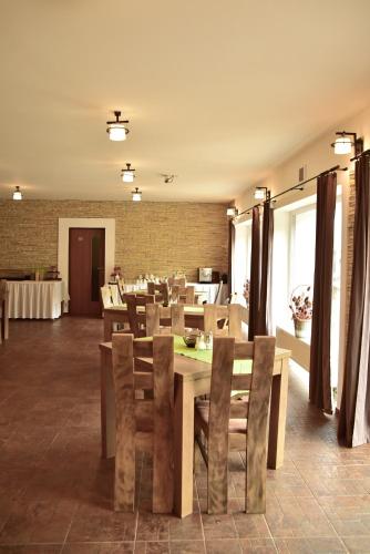 a dining room with a wooden table and chairs at Pension U Krbu in Mikulov v Krušných Horách