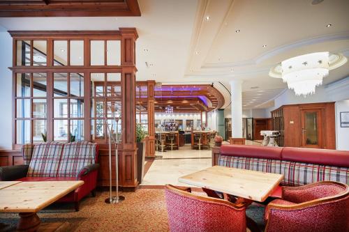 a restaurant with couches and tables in a room at Hotel EDELWEISS Berchtesgaden Superior in Berchtesgaden