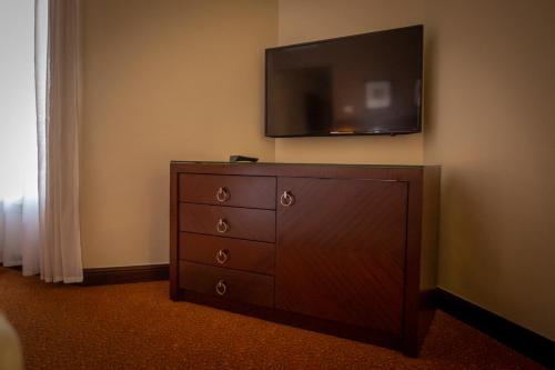 a dresser with a flat screen tv on a wall at Hotel Atlantic Agdal in Rabat