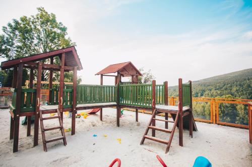 a playground with two chairs and a gazebo at Hotel & Medi-Spa Biały Kamień in Świeradów-Zdrój