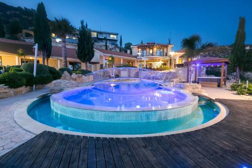 a large swimming pool in the middle of a house at Oceania & Panorama Villas in Peyia