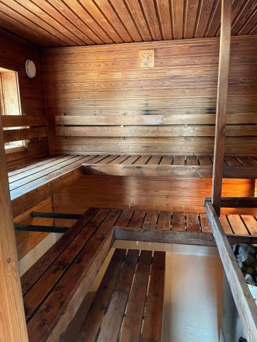 an empty sauna with wooden walls and ceilings at Kaunissaaren Maja in Kotka