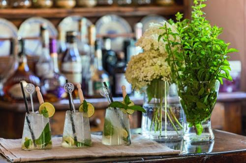 a table with a bunch of vases with flowers in them at Bellevue Hotel & SPA in Cogne
