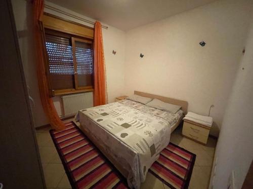 a small bedroom with a bed and a window at Palazzina Rosa in Spormaggiore