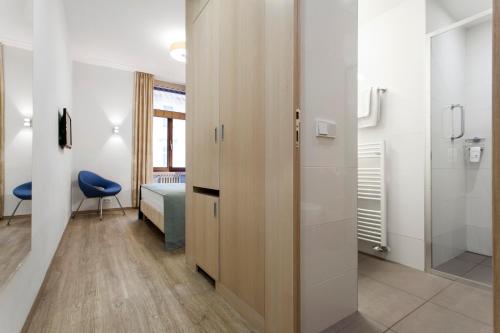 a room with a sliding door and a bedroom at Hotel Carol in Prague