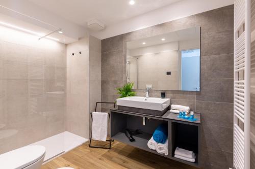 a bathroom with a sink and a mirror at VistaLago Torbole in Nago-Torbole