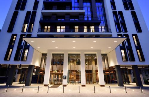 an external view of a tall building with windows at Milano Verticale | UNA Esperienze in Milan