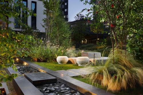 a garden with rocks and plants in a building at Milano Verticale | UNA Esperienze in Milan