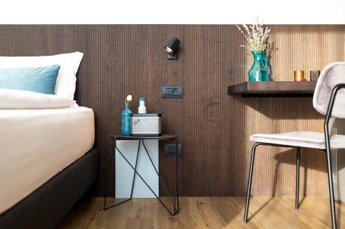 a bedroom with a bed and a table and a chair at VistaLago Torbole in Nago-Torbole