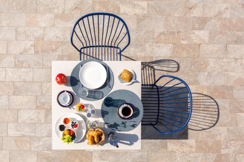 a table with a plate of food on a chair at VistaLago Torbole in Nago-Torbole