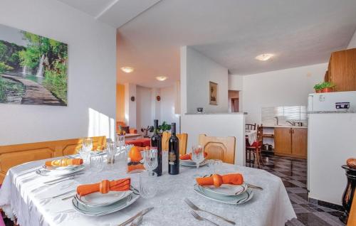 a kitchen with a table with plates and napkins on it at Apartments Topalović in Kostrena