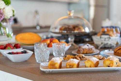a counter topped with plates of pastries and other foods at Agriturismo Bressani in Nimis