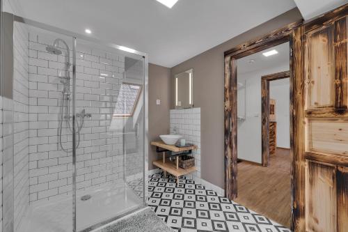 a bathroom with a shower and a toilet and a sink at Joy Aparthotel Keilberg in Klínovec