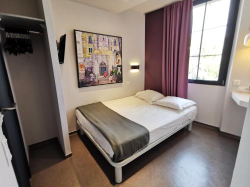 Dormitorio pequeño con cama y lavamanos en 7Art Hotel, en Cannes