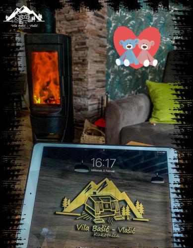 a picture of a living room with a fireplace at Vila Bašić Vlašić Spa Apartman JELEN in Vlasic