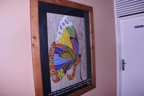a picture of a colorful painting on a wall at Bethel Resort & Hotels in Gulu
