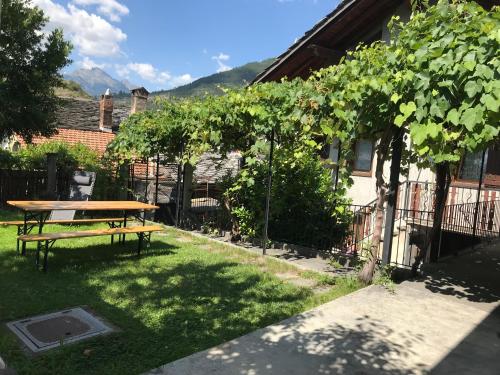 a picnic table in the yard of a house at Appartamenti Il Castello in Saint-Pierre