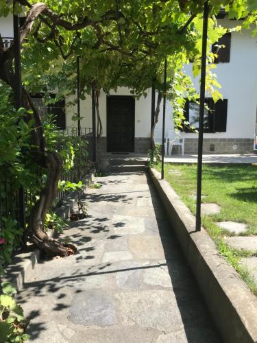 a walkway in front of a building with trees at Appartamenti Il Castello in Saint-Pierre