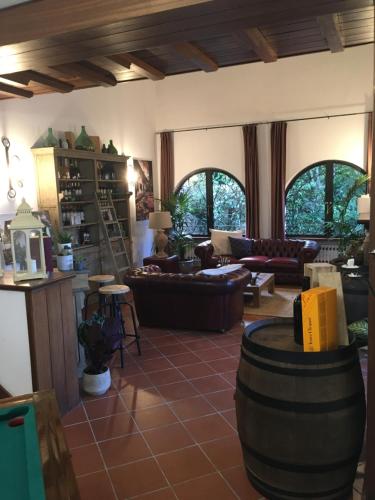 a living room with couches and chairs and a table at Casale I Tigli in Lucca