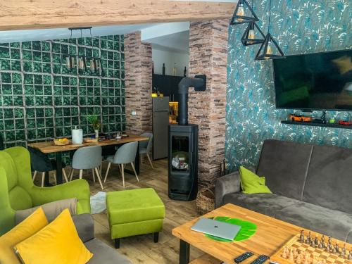 a living room with a couch and a table at Vila Bašić Vlašić Spa Apartman JELEN in Vlasic
