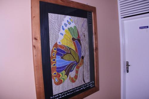 a picture of a colorful painting on a wall at Bethel Resort & Hotels in Gulu