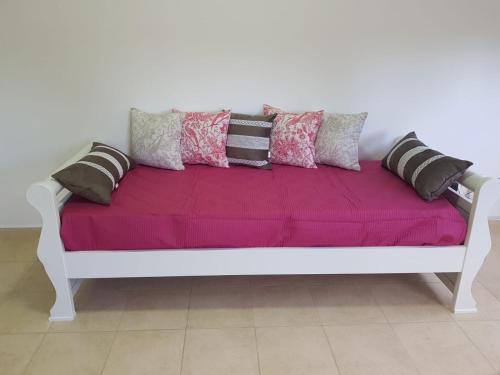 a white bench with pillows on top of it at Alto Magallanes in Ushuaia
