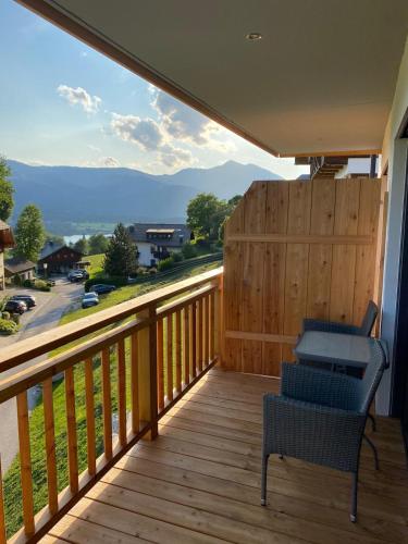 a balcony with a chair and a view of the mountains at Ferienappartements Familie Jakob in St. Wolfgang