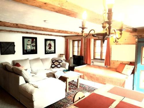 a living room with a couch and a bed at Chalet St Jakob in Sankt Anton am Arlberg