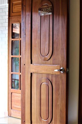 a wooden door with a sign on it at Amazilia Hotel in Pereira