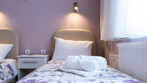 a small room with a bed with towels on it at Casablanca in Niš