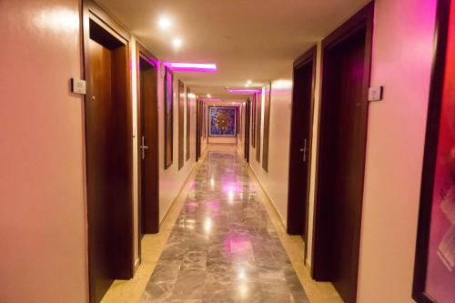a long hallway with pink and purple lights at Hotel du Golfe in Lomé