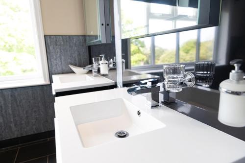 a bathroom with two sinks and a window at Park Manor Hotel in Scarborough