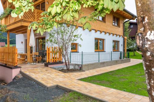 a house with a patio in front of it at Chalet Mandl Sauna Pool Rollstuhlgängig in Maishofen