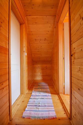 a hallway with a rug in a wooden room at Holiday home Drveni Kutak in Sekulić 
