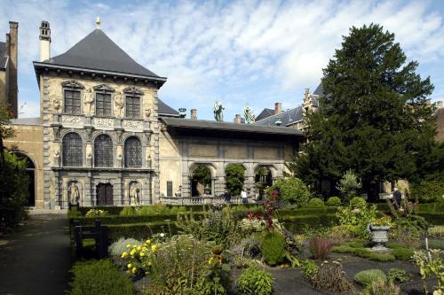 an old building with a garden in front of it at Radisson Blu Hotel, Antwerp City Centre in Antwerp