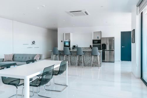 a living room with a white table and chairs at Gray Door Apartments - Adults only in Palm-Eagle Beach