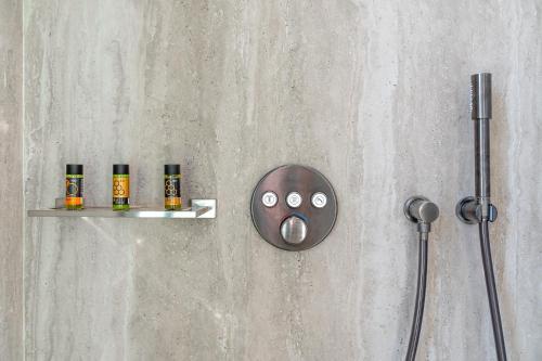 a wall with a shower with a face drawn on it at Hellenic Vibes Smart Hotel in Athens