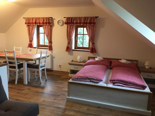 1 dormitorio con cama y mesa de comedor en Matějovec 109 & Ubytování Na statku, en Český Rudolec