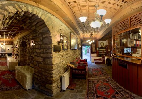 a large room with a stone fireplace in a house at Huma Hatun Konakları Hotel in Safranbolu