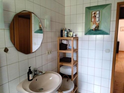 a bathroom with a sink and a mirror at Apartments Angela in Wiesau
