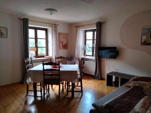 a dining room with a table and chairs in a room at Apartments Angela in Wiesau