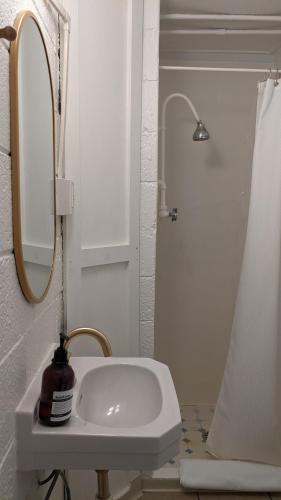 a bathroom with a sink and a mirror and a shower at Anchor Inn in Traverse City