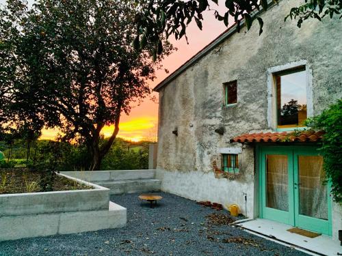 a building with a sunset in the background at Samson and the Lilo in Vipava