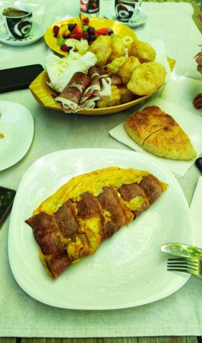 a slice of pizza on a white plate on a table at KOZAK Apartments & Restaurant in Mojkovac